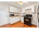 Well-lit kitchen featuring white cabinets, neutral countertops and hardwood floors at 164 Torain St, Hillsborough, NC 27278