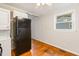 Bright kitchen with hardwood floors, white cabinets and black appliances at 164 Torain St, Hillsborough, NC 27278