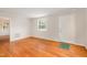 Inviting living room featuring hardwood floors, neutral walls, and ample natural light at 164 Torain St, Hillsborough, NC 27278