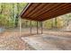 Image of a concrete patio in a backyard setting with a wood cover overhead at 164 Torain St, Hillsborough, NC 27278