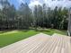 Expansive backyard view showing a freshly mowed lawn extending towards a dense tree line at 170 Cherry Bark Dr, Youngsville, NC 27596