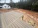 New backyard deck view features a clean outdoor space with wooded area just beyond at 170 Cherry Bark Dr, Youngsville, NC 27596