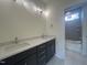 Bathroom featuring a double sink vanity with modern lighting and a separate shower/tub area at 170 Cherry Bark Dr, Youngsville, NC 27596