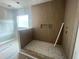 Unfinished bathroom showcasing vertical wood tile in shower with accent wall and river stone flooring at 170 Cherry Bark Dr, Youngsville, NC 27596