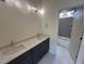 A modern bathroom with double sinks, quartz countertops, and a separate bathtub and shower with tile surround at 170 Cherry Bark Dr, Youngsville, NC 27596