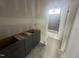 Bathroom featuring a modern vanity and a tub with tiled walls at 170 Cherry Bark Dr, Youngsville, NC 27596
