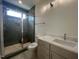 Bathroom featuring a glass enclosed shower and modern vanity with solid surface countertop and decorative lighting at 170 Cherry Bark Dr, Youngsville, NC 27596