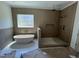 Bathroom showcasing a freestanding tub and a tiled walk-in shower at 170 Cherry Bark Dr, Youngsville, NC 27596