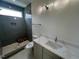 Well-lit bathroom featuring a tiled walk-in shower and a vanity with a white countertop and single sink at 170 Cherry Bark Dr, Youngsville, NC 27596