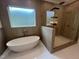 Modern bathroom featuring a soaking tub and glass-enclosed shower at 170 Cherry Bark Dr, Youngsville, NC 27596
