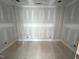 Spacious unfinished bedroom with vertical slat accent wall showing electrical outlets at 170 Cherry Bark Dr, Youngsville, NC 27596