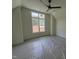 Bedroom featuring a ceiling fan and window offering natural light, with protective plastic sheeting on the floor at 170 Cherry Bark Dr, Youngsville, NC 27596