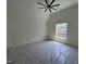 Bright bedroom featuring a ceiling fan and a large window overlooking the greenery outside at 170 Cherry Bark Dr, Youngsville, NC 27596