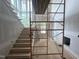 Spacious unfinished entryway featuring large windows, stairs, and scaffolding for high ceilings at 170 Cherry Bark Dr, Youngsville, NC 27596