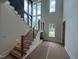Grand entryway featuring a staircase with metal accents, large windows, and modern lighting at 170 Cherry Bark Dr, Youngsville, NC 27596