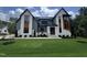 Stunning two-story home featuring a modern design with a lush green lawn and meticulous landscaping at 170 Cherry Bark Dr, Youngsville, NC 27596