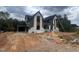 Two-story home with white brick, gray siding, black roof and an attached garage on a large lot at 170 Cherry Bark Dr, Youngsville, NC 27596