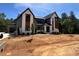 Stunning new construction home boasts a modern design and beautiful curb appeal with large windows and gray accents at 170 Cherry Bark Dr, Youngsville, NC 27596