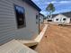 Home exterior with gray siding, window, and partial view of the expansive backyard at 170 Cherry Bark Dr, Youngsville, NC 27596