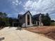 New two-story home features modern architectural design, attached garage, and concrete driveway at 170 Cherry Bark Dr, Youngsville, NC 27596