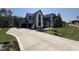 A view of the long driveway leading to a modern two-story house with an attached garage at 170 Cherry Bark Dr, Youngsville, NC 27596