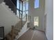 Bright foyer with wood stairs, modern railings, and large windows at 170 Cherry Bark Dr, Youngsville, NC 27596