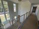 Second floor foyer features modern railing with view of large windows at 170 Cherry Bark Dr, Youngsville, NC 27596