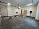 Spacious two-car garage with ample room for vehicles, work and storage, illuminated by bright lighting at 170 Cherry Bark Dr, Youngsville, NC 27596