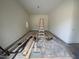 Empty garage space with a ladder and building materials awaiting conversion at 170 Cherry Bark Dr, Youngsville, NC 27596