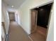 Hallway with recessed lighting, neutral walls, and door with a glass panel at 170 Cherry Bark Dr, Youngsville, NC 27596