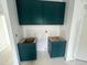 Modern kitchen features emerald green cabinets and ample storage space at 170 Cherry Bark Dr, Youngsville, NC 27596