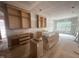 Unfinished kitchen with natural wood cabinets and large window at 170 Cherry Bark Dr, Youngsville, NC 27596