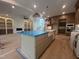A kitchen showcases modern cabinetry, stainless steel appliances, an island with a farmhouse sink, and pendant lighting at 170 Cherry Bark Dr, Youngsville, NC 27596