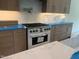 A kitchen showcases modern cabinetry, stainless steel appliances, and a designer backsplash at 170 Cherry Bark Dr, Youngsville, NC 27596