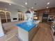 Open concept kitchen with large island and open to a living room with a fireplace at 170 Cherry Bark Dr, Youngsville, NC 27596