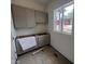 Modern laundry room featuring stylish gray cabinets and ample natural light at 170 Cherry Bark Dr, Youngsville, NC 27596