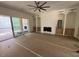 Bright open-concept living room with built-in shelving, fireplace, and access to the back patio at 170 Cherry Bark Dr, Youngsville, NC 27596