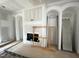 Unfinished living room displaying a fireplace and detailed trim work with arched built-in shelving at 170 Cherry Bark Dr, Youngsville, NC 27596