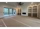 A spacious living room features built-in shelving, a fireplace, and access to an outdoor area at 170 Cherry Bark Dr, Youngsville, NC 27596