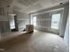 Unfinished living room with natural light from two windows and doorway providing an open feel at 170 Cherry Bark Dr, Youngsville, NC 27596