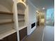 A living room features built-in shelving, a fireplace, and a staircase to the upper level at 170 Cherry Bark Dr, Youngsville, NC 27596