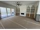 Spacious living room features fireplace with custom built-ins and sliding glass door at 170 Cherry Bark Dr, Youngsville, NC 27596