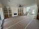 Open-concept living room with custom built-in shelves and access to the staircase at 170 Cherry Bark Dr, Youngsville, NC 27596