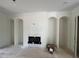Living room with fireplace framed by arched built-in shelves and white walls at 170 Cherry Bark Dr, Youngsville, NC 27596