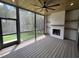 Enjoy the outdoors in this screened porch with a fireplace, wood ceiling, and ceiling fan at 170 Cherry Bark Dr, Youngsville, NC 27596