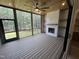 Inviting screened porch with a wood ceiling, ceiling fan, fireplace, and private wooded views at 170 Cherry Bark Dr, Youngsville, NC 27596