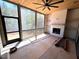 Screened porch boasts a wood ceiling, fireplace and a view of the trees at 170 Cherry Bark Dr, Youngsville, NC 27596