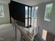 Staircase with many windows showcasing the natural sunlight and view outside at 170 Cherry Bark Dr, Youngsville, NC 27596