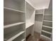Spacious walk-in closet with white built-in shelving and rods for organized storage at 170 Cherry Bark Dr, Youngsville, NC 27596