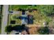 Birds eye view of the property with a house, deck, green backyard, and mature trees at 1805 Lawrence Rd, Hillsborough, NC 27278